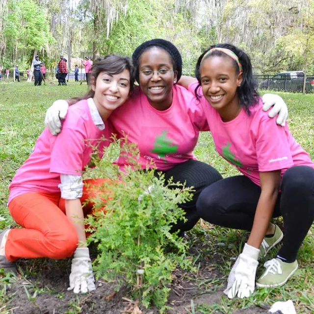 Three volunteers smiling.