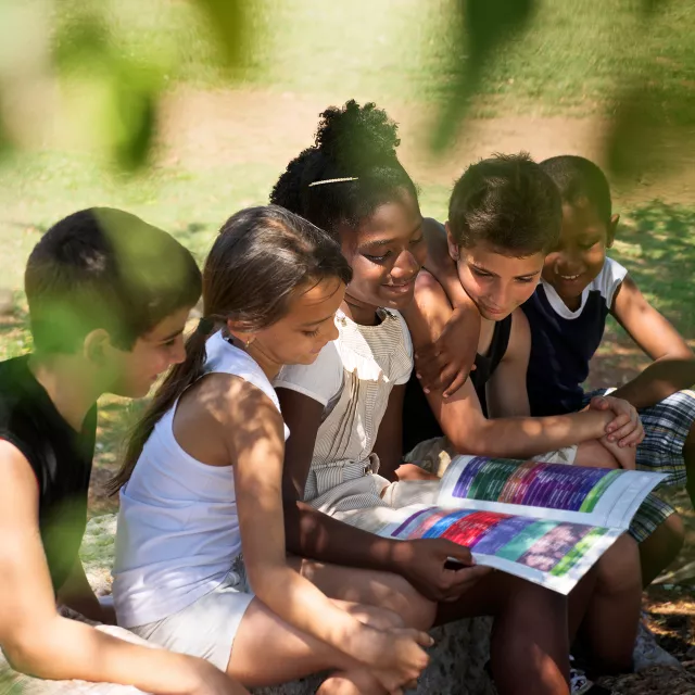 kids learning outside under a tree