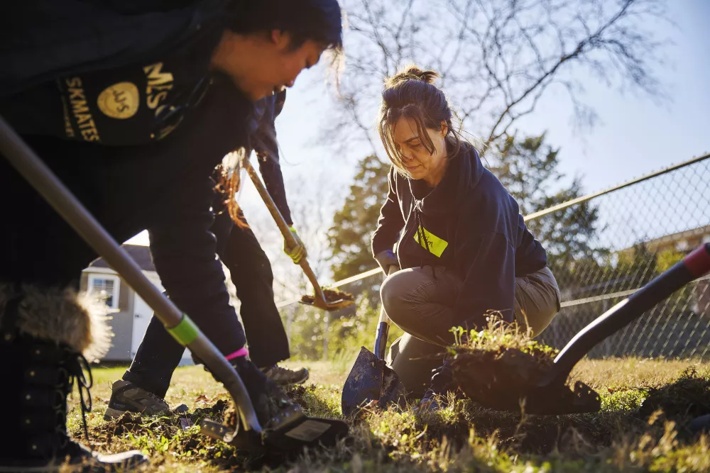 Image of people planting trees in a community