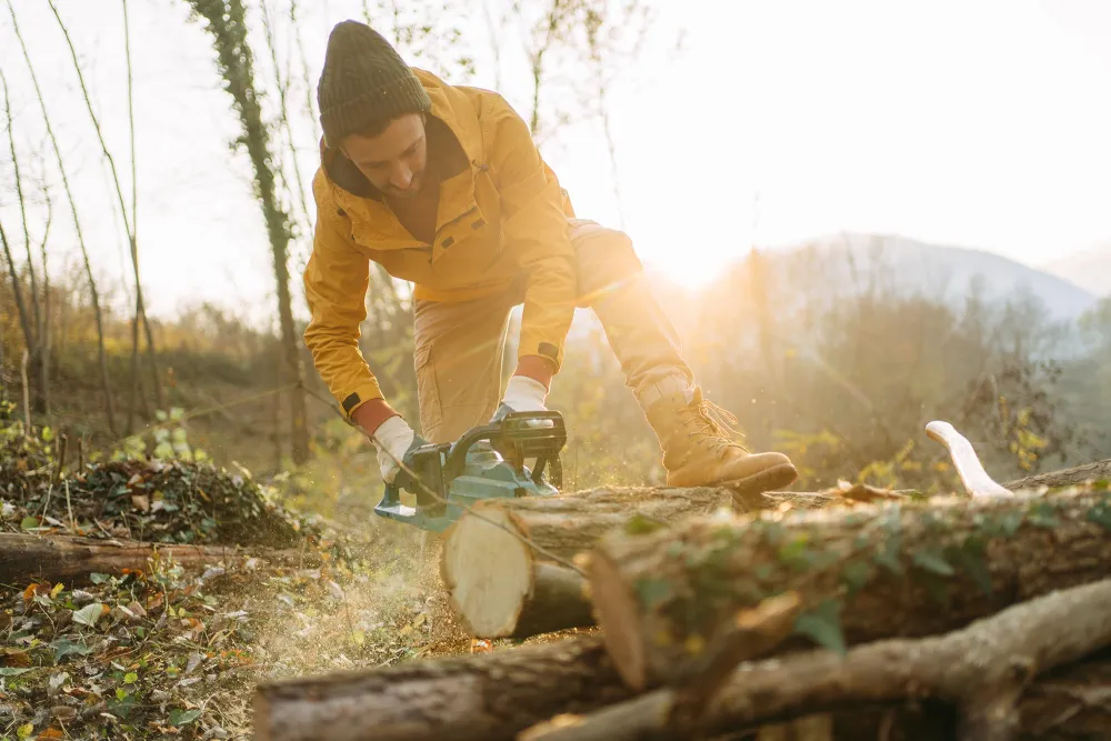 a person using a chainsaw