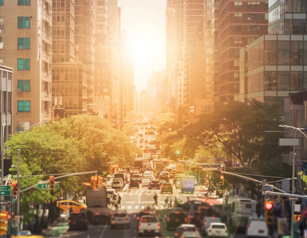 sunset reflecting off of busy city street