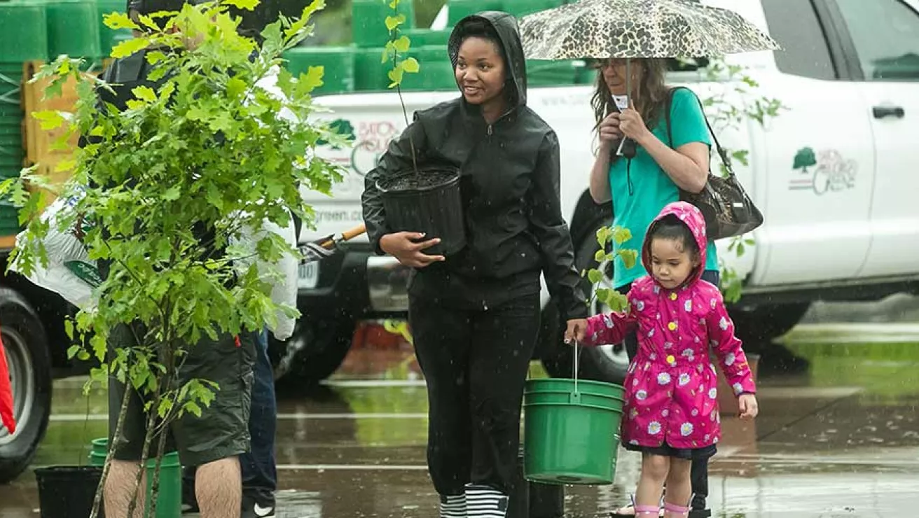 Family at tree distribution event