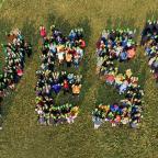 Overhead shot of people gathered to spell out the word 'Yes!'